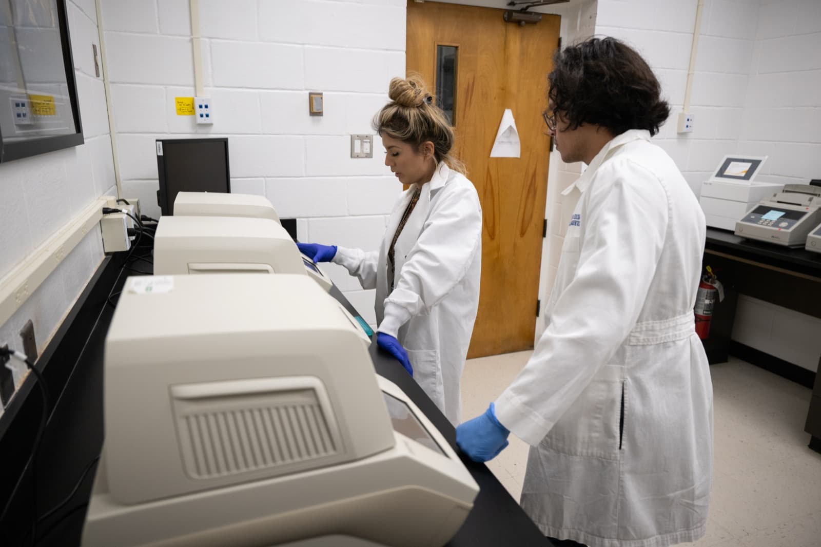Scientists working at instruments in a modern molecular research laboratory